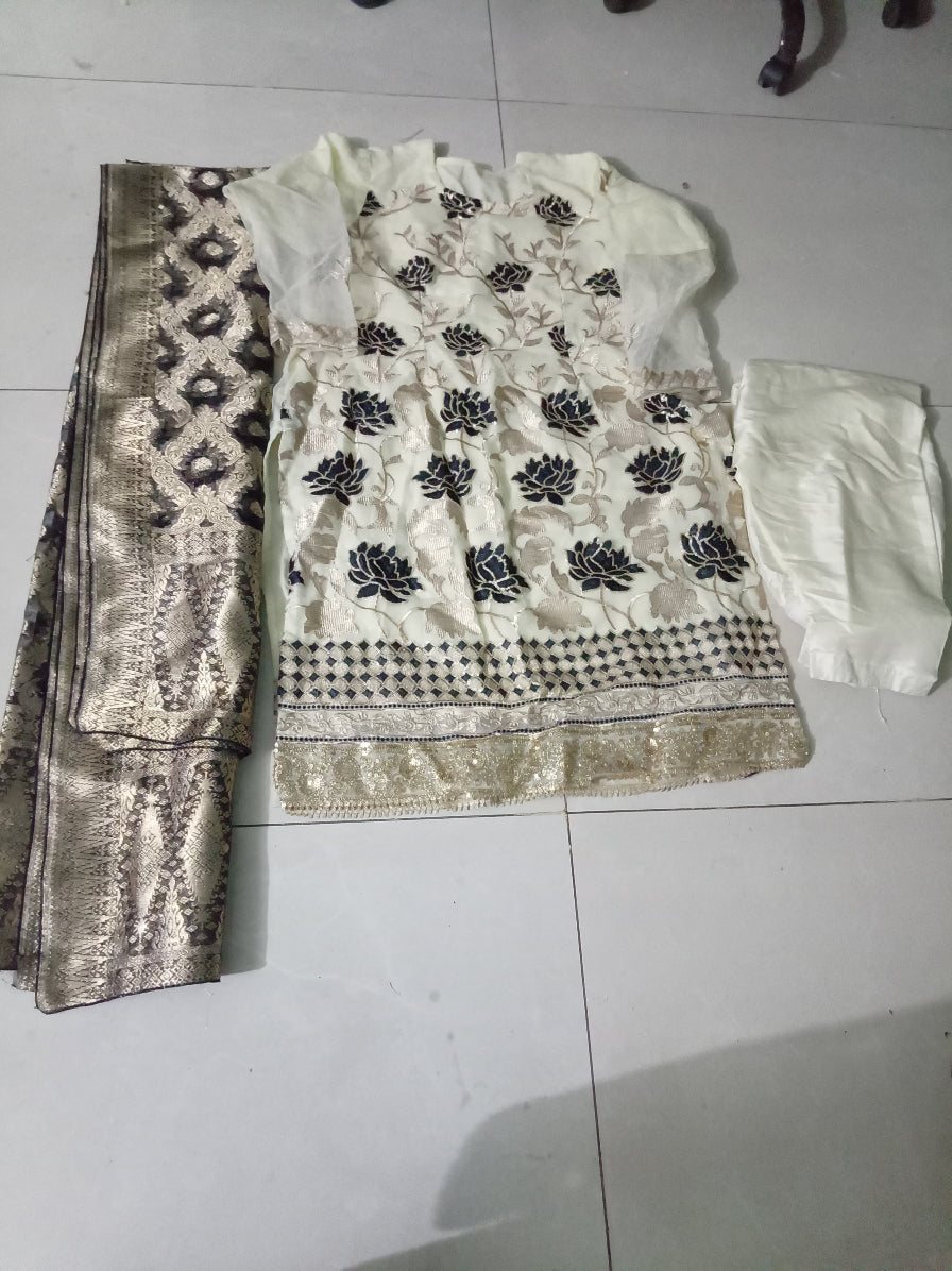 White fabric with black floral patterns on a tiled floor